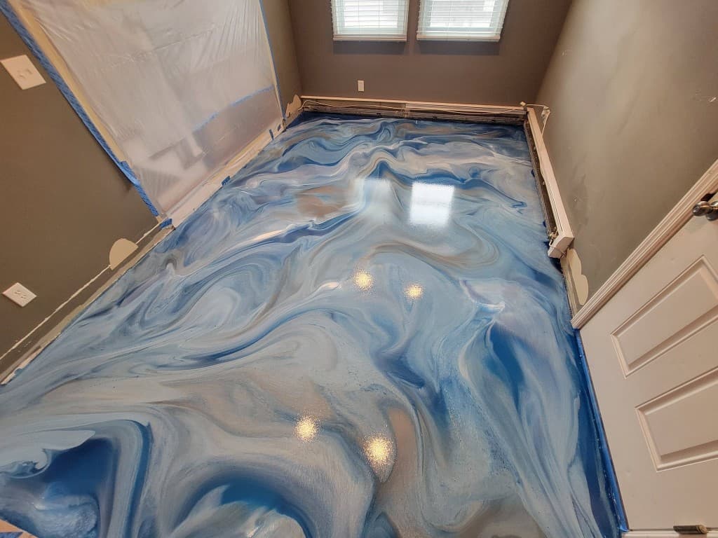 High-gloss metallic epoxy floor with blue and pearl-white swirl movement — Central New York